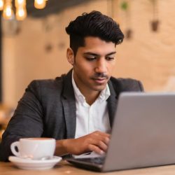 young-businessman-working-with-his-laptop-cafe_713888-20655